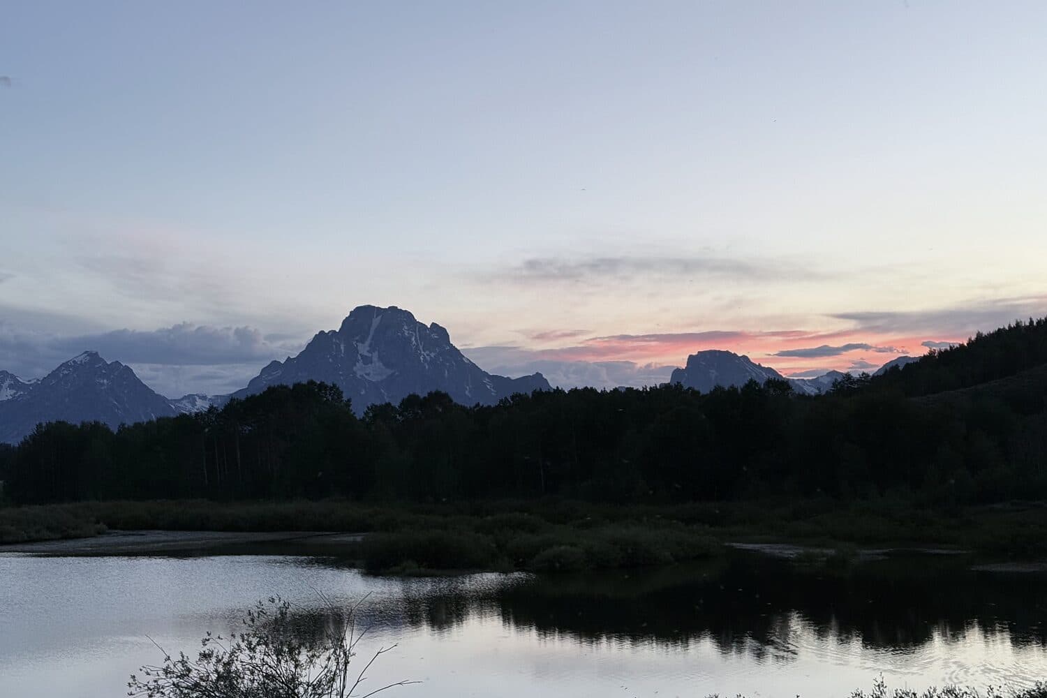 Mount Moran above the still water of Oxbow Bend as the last light leaves the range, Grand Teton, Wyoming