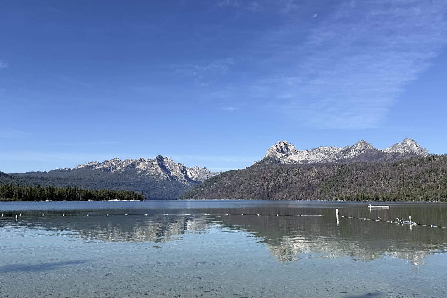 The Sawtooth Range held in the shallows of Redfish Lake, Idaho