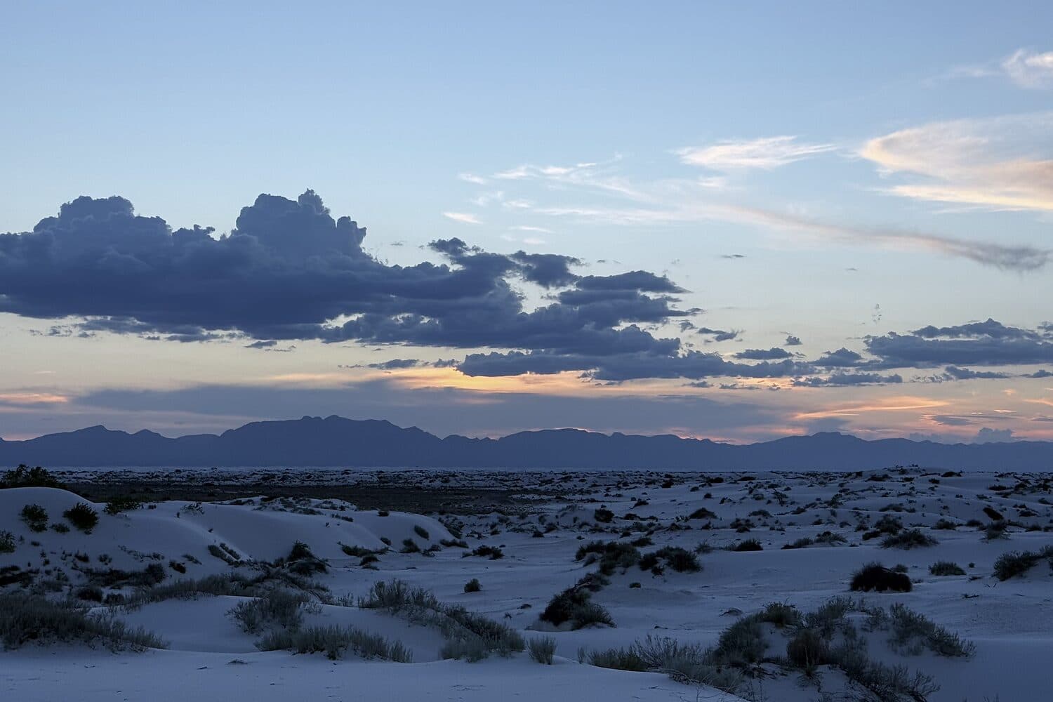 The gypsum dune field flattening into blue at dusk, White Sands, New Mexico