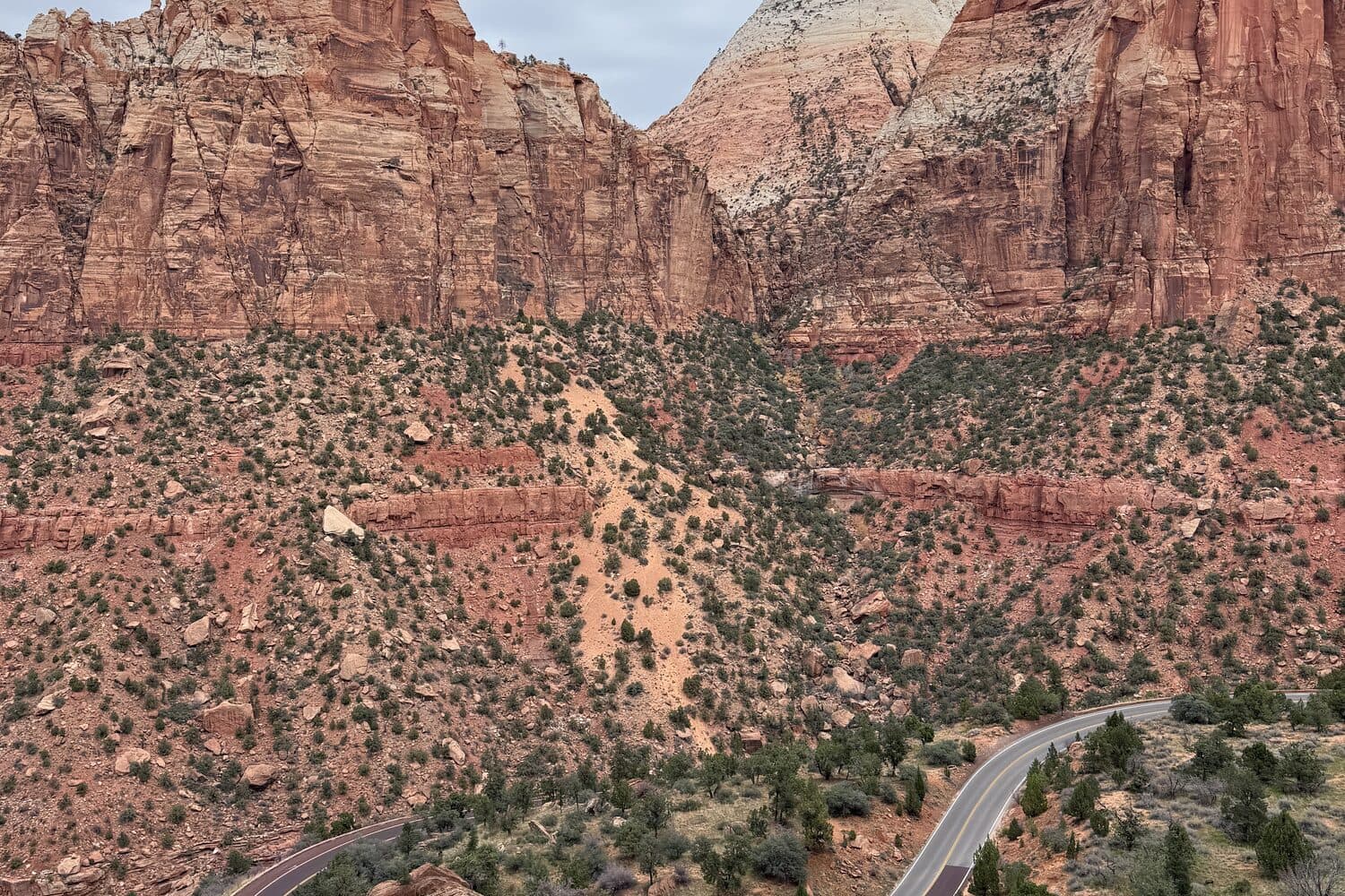 The switchback road climbing the canyon wall below the sandstone cliffs, Zion, Utah