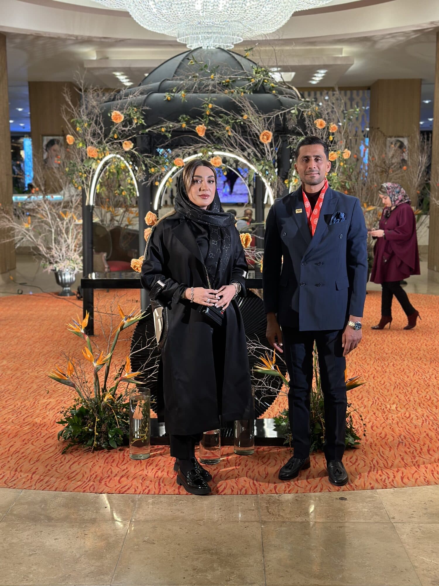 Two guests photographed together at the monument before the hall opened