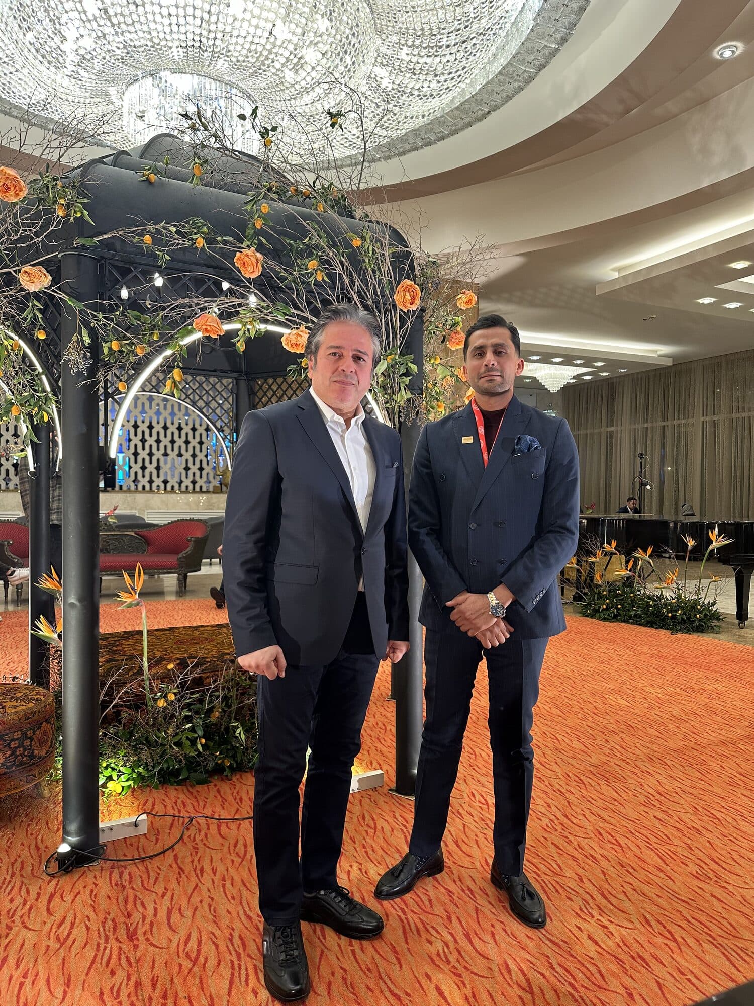 Two guests at the monument in the lobby as the evening begins