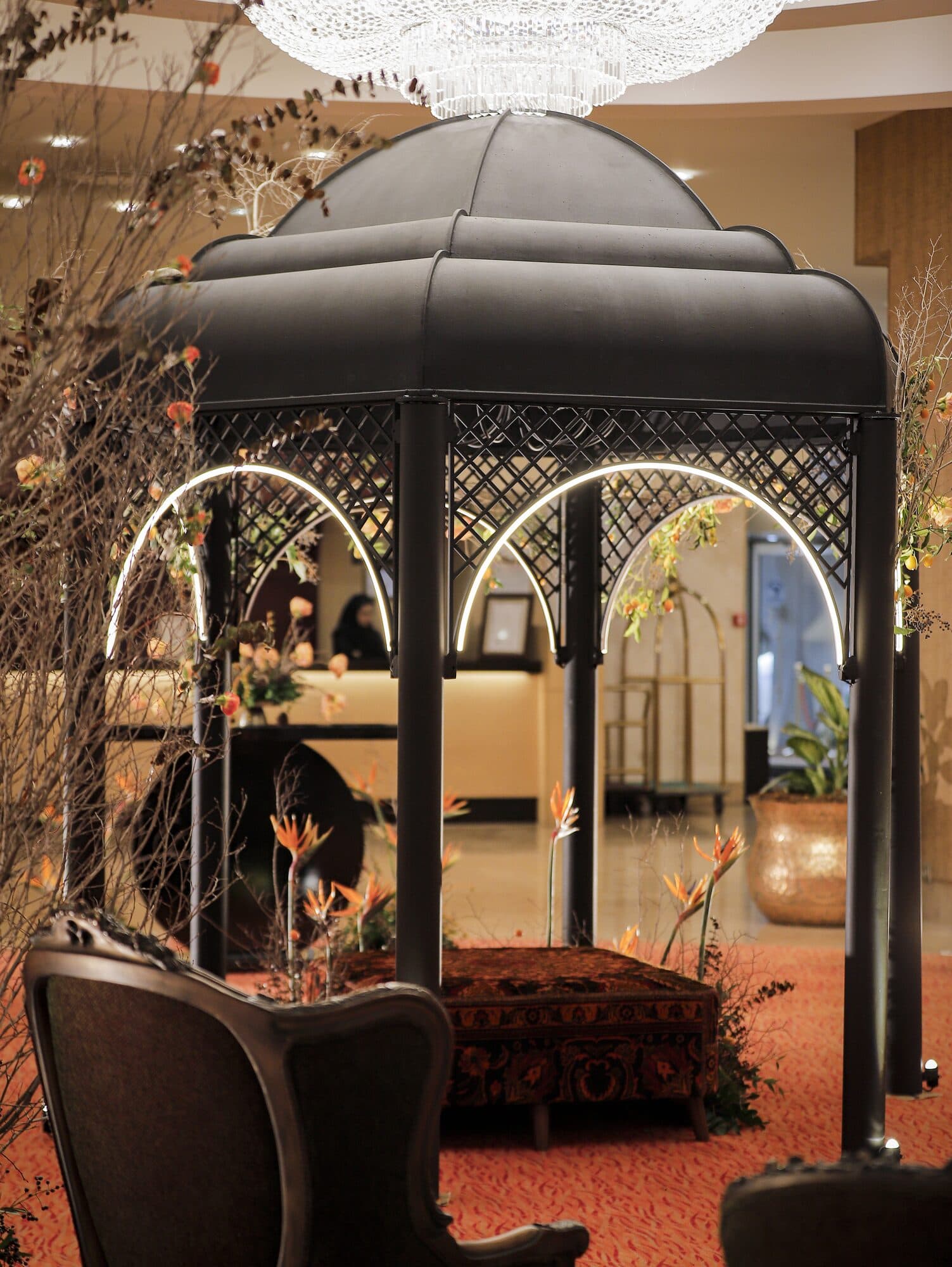 The recreated tomb of Hafez standing in the middle of the hotel lobby, lit and flowered