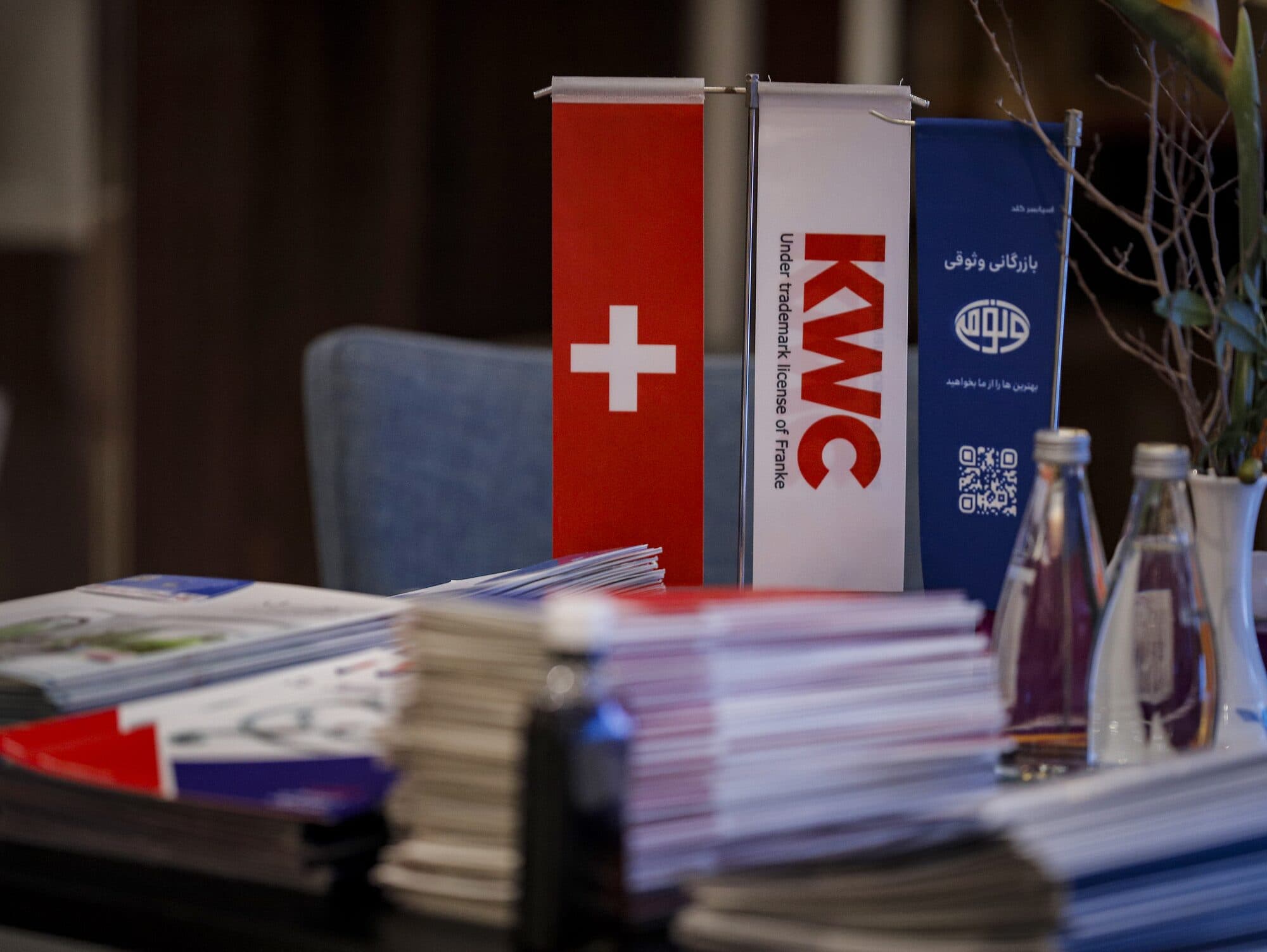 A sponsor's banner and printed material on the reception table at the entrance