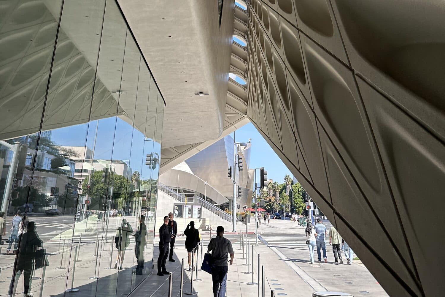 The walkway along the underside of the veil, visitors moving toward the entrance