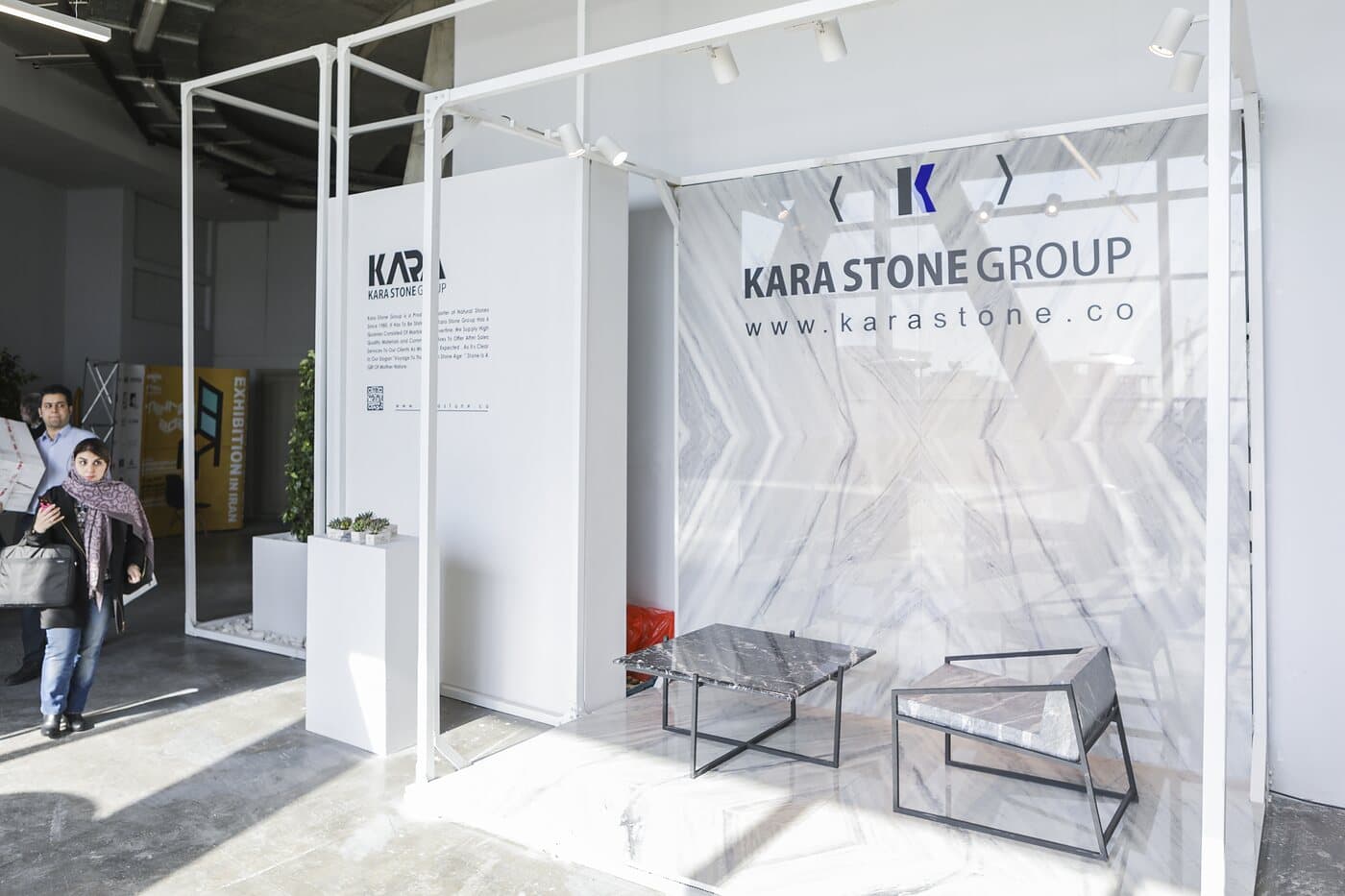 The KARA STONE GROUP setting, stone laid the length of a white frame — WINDOW DISPLAY, Tehran 2020