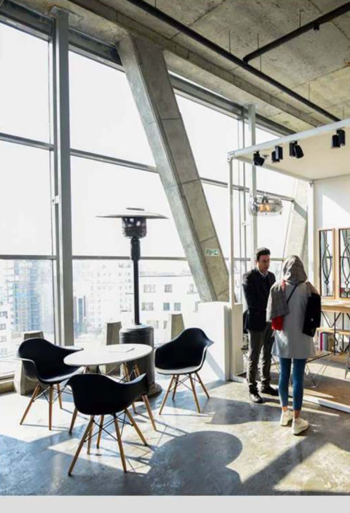 Industry professionals meeting in a daylit concrete interior